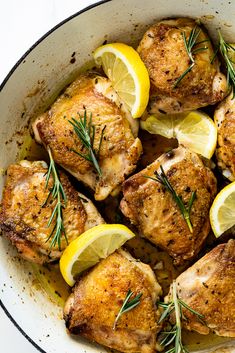 chicken with lemons and rosemary in a skillet