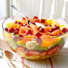 a fruit salad in a glass bowl on a table