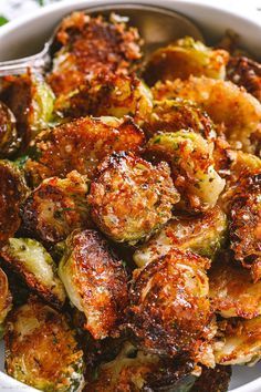 a white bowl filled with cooked brussel sprouts