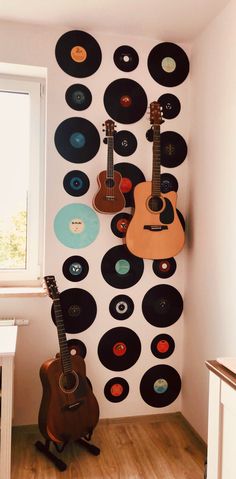 a room with guitars and records on the wall