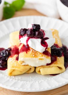 crepes topped with blueberries and whipped cream