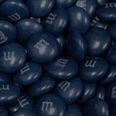 blue chocolate candies with letters and numbers on them are shown in close up view