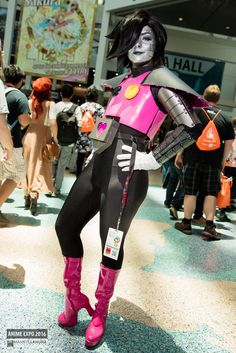 a woman dressed as a skeleton is standing in the middle of a crowded area with other people