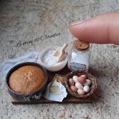 a miniature tray with bread, eggs and other items on it that are sitting on a table