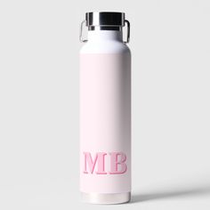 a pink water bottle with the word'm b'on it, sitting in front of a white background