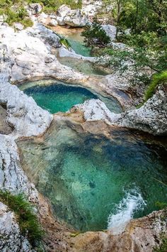 the water is blue and green in this rocky area