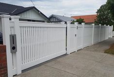 a white picket fence in front of a house