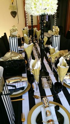 a black and white striped table setting with flowers