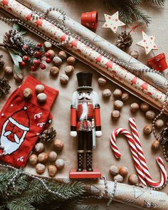 the nutcracker is surrounded by christmas decorations and candy canes on the table