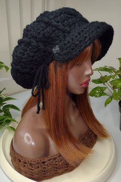 a mannequin head wearing a black knitted hat