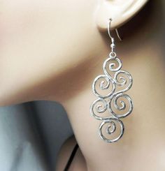 These sterling silver swirl earrings are a FantaSea original design from the Ocean Swirl Collection. The multi swirl earrings are big and long, yet comfortable if you like larger, “statement” style earrings. Big swirls and spirals make a big impact and the texture and swirl pattern is reminiscent of the waves of the ocean sparkling in the sunlight. DETAILS: Sterling silver swirls Sterling silver French ear wires Hammer textured approx. 2-3/4" long including wire Just like the ancient Petroglyph Silver Swirl Earrings, Unique Silver Swirl Earrings, Wrapping Crystals, Waves Of The Ocean, Organic Earrings, Aluminum Earrings, Ear Ring, Earrings Big, Swirl Ring