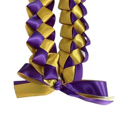 the purple and gold ribbon is tied up with a large bow on it's side