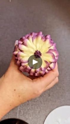 a person holding a flower in their hand with the video below it to see what they are doing