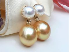 "Luxurious rich golden South Sea drop pearls dangling beneath six-prong set white freshwater pearl studs in solid 14k yellow gold. Timeless and classic pearl earrings. A fabulous addition to your jewelry collection. ✤ South Sea golden pearls are approx. 12.5 x 10.7mm, medium golden color. Very high luster, smooth surface with a few blemishes / very minor natural imperfection. ✤ South Sea pearl origin: Philippines. ✤ White freshwater pearls are 7mm, very high luster and smooth surface. ✤ Earrings Classic Pearl Earrings, Drop Pearl Earrings, Golden Pearl, Gold Pearl Earrings, Sea Pearl, White Freshwater Pearl, Sea Pearls, Golden Color, Pearl Studs