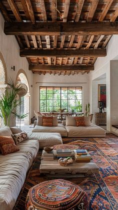 a living room filled with lots of furniture next to a large rug covered flooring