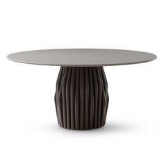 a round table with an unusual design on the top, and a circular base in grey