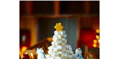 a white christmas tree made out of marshmallows and gold stars on top