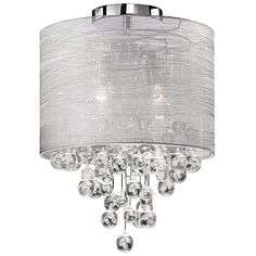 a chandelier hanging from the ceiling with white fabric and crystal balls on it