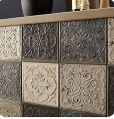 decorative tiles on the back of a kitchen counter