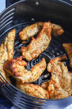 chicken wings being cooked in an air fryer