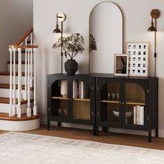 a living room with a book shelf, mirror and vase on the floor next to stairs