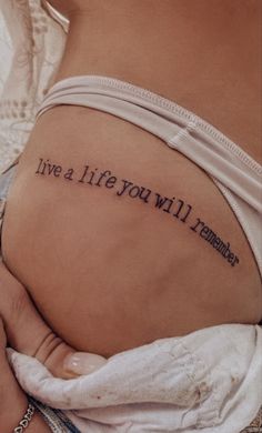 a woman with a tattoo on her stomach saying live a life you will never forget