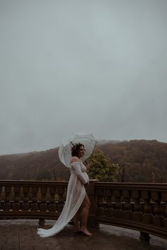 a woman in white dress holding an umbrella