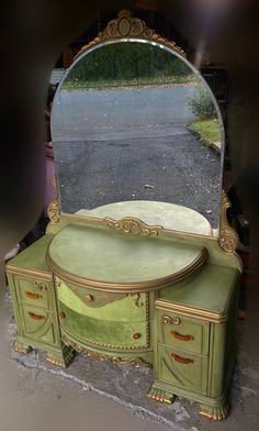 an antique vanity with a large mirror on it's sideboard and drawers in the middle