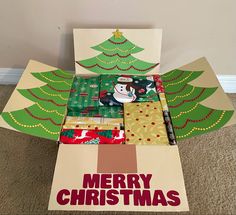 an open christmas card box sitting on the floor