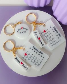 four personalized key chains on a plate