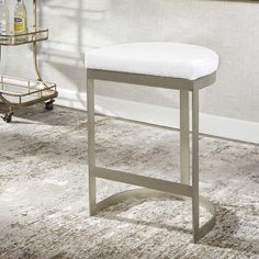 a white counter top sitting on top of a rug next to a chair and table