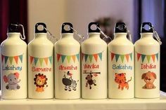 four personalized water bottles with animals on them