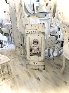 an old photo frame sitting on top of a wooden floor next to chairs and tables