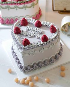 two heart shaped cakes sitting on top of a table