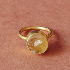 For every November born who desire the gift of protection and strength, this natural citrine ring is a design which proves to be a dream come true. The birthstone comes in a delicate stackable design which leaves no room for any fashion compromise for the wearer making this an ideal gift choice.  Elegant 18K Yellow Gold Plated Natural Raw Citrine Brass Stone Ring, Round Stone Stacking Ring, Unique Birthstone Ring For Women Product Details Item Code: BJBR-1743 Stone Name: Citrine Stone Size: 10 mm Metal: 18K Yellow Gold Plated Over Brass Ring Sizes: Please choose from drop down menu. If you do not see your finger size, select custom and I'll make a ring just for you!  Note:- These rings you will receive may vary slightly in color from the images because these are natural gemstones and vary Citrine Birthstone Crystal Ring Fine Jewelry, Fine Jewelry Citrine Crystal Ring With Birthstone, Gold Topaz Birthstone Ring Gift, Gold Rings With Natural Stones And Citrine, Minimalist Topaz Rings As Gifts, Yellow Citrine Birthstone Ring, Dainty Citrine Round Jewelry, Dainty Round Citrine Jewelry, Yellow Citrine Crystal Ring