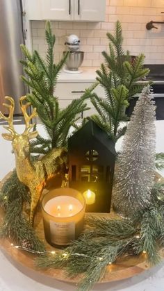 a candle and some christmas decorations on a table