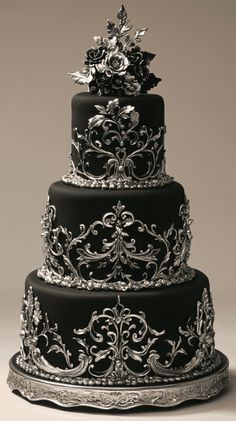 a three tiered black and silver wedding cake