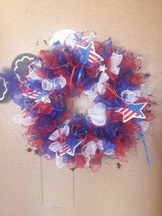 a red, white and blue wreath hanging on the wall