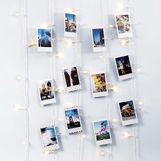 several polaroid pictures are hung on a string of lights