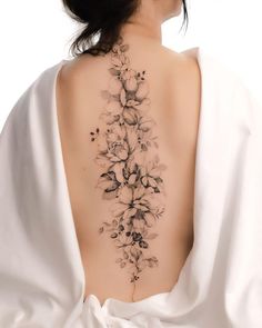 the back of a woman's neck with flowers on it