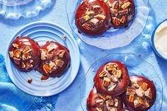 chocolate covered donuts with nuts and cream on blue plates next to bowls of yogurt