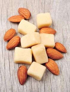 almonds and cheese on a wooden table