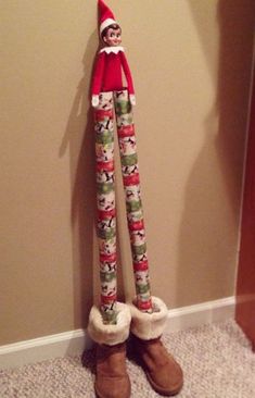 the elf is leaning against the wall with his legs up