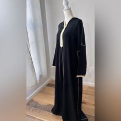 Message Me Your Size Available In (M, L, Xl) Model Is 5’5 Tall Medium Size And Abaya Is Floor Lenght On Model Introducing Our Caftan Abaya Dress With Hood - An Elegant, Modest Garment Perfect For Any Occasion. This Dress Boasts A Unique Design Featuring A Hood, Adding A Touch Of Sophistication To Your Wardrobe. Crafted With High-Quality Materials, This Caftan Abaya Dress Is Both Comfortable And Durable. Its Loose-Fitting Design Allows For Easy Movement And Breathability, While The Hood Provides Black V-neck Abaya For Eid, Long Modest Abaya With Dabka, Modest Long Abaya For Eid, Long Thobe With Modesty Panel For Eid, Long Abaya With Modesty Panel For Eid, Eid Abaya With Modesty Panel, Abaya Luxury, Plus Size Abaya, Abaya Modest