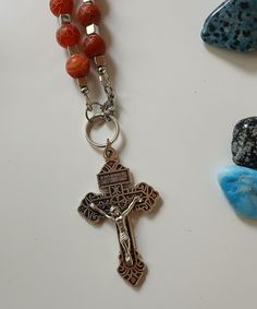 This necklace features Red frosted agate Beads and clasps in the front. The Pardon Crucifix is a special sacramental. Those who wear the pardon Crucifix may obtain special graces and indulgences. On the back of the Pardon Crucifix is written,  "Father, forgive them." and, "Behold this Heart which has so loved men." Spiritual Carnelian 8mm Bead Jewelry, Spiritual Carnelian 8mm Beaded Jewelry, Spiritual Crucifix Jewelry With 8mm Beads, Spiritual Carnelian Beads Jewelry 8mm, Spiritual Carnelian Jewelry With 8mm Beads, Adjustable Cross Necklace With 8mm Beads, Spiritual Rosary With Natural Stones As Gift, Spiritual Crucifix Necklace With 8mm Beads, Spiritual Beaded Cross Pendant Jewelry