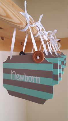 there is a sign hanging from the ceiling that says newborn on it and has buttons attached to it