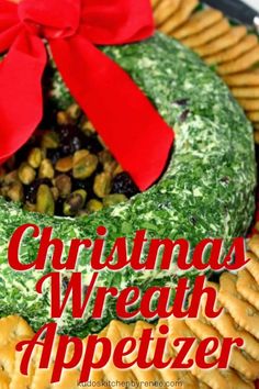 a christmas wreath appetizer is displayed on a platter with crackers and pretzels