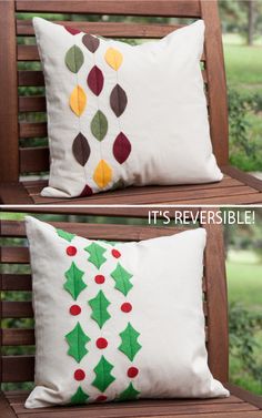 two pillows with christmas decorations on them sitting on a wooden bench in front of trees