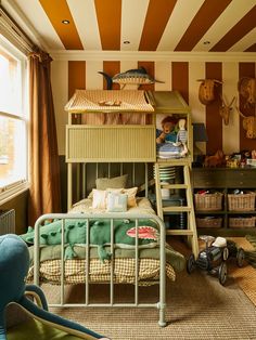 there is a bunk bed in the children's room with striped walls and flooring