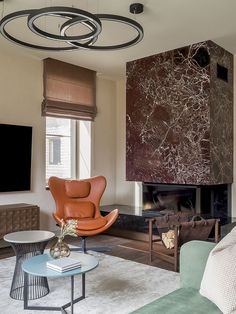 a living room filled with furniture and a flat screen tv mounted on the wall above a fireplace